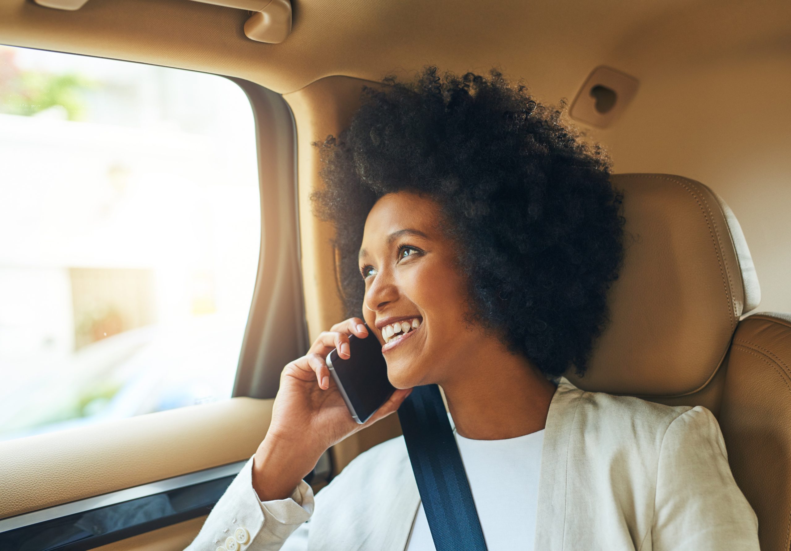 Passenger using her phone while travelling with TKAY Transport Logistics